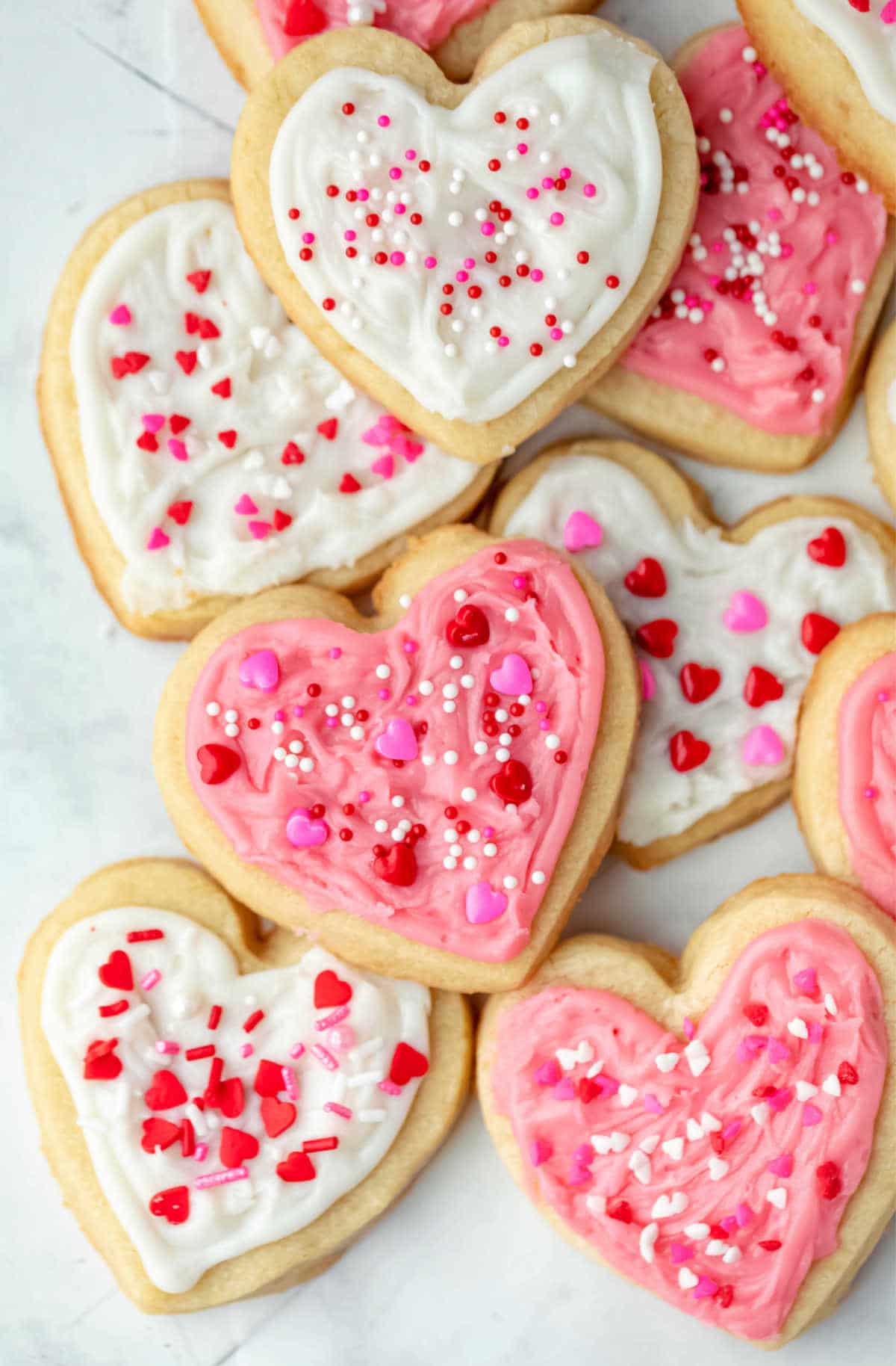 Stack of Valentine's Day cookies on a piece of parchment paper. 