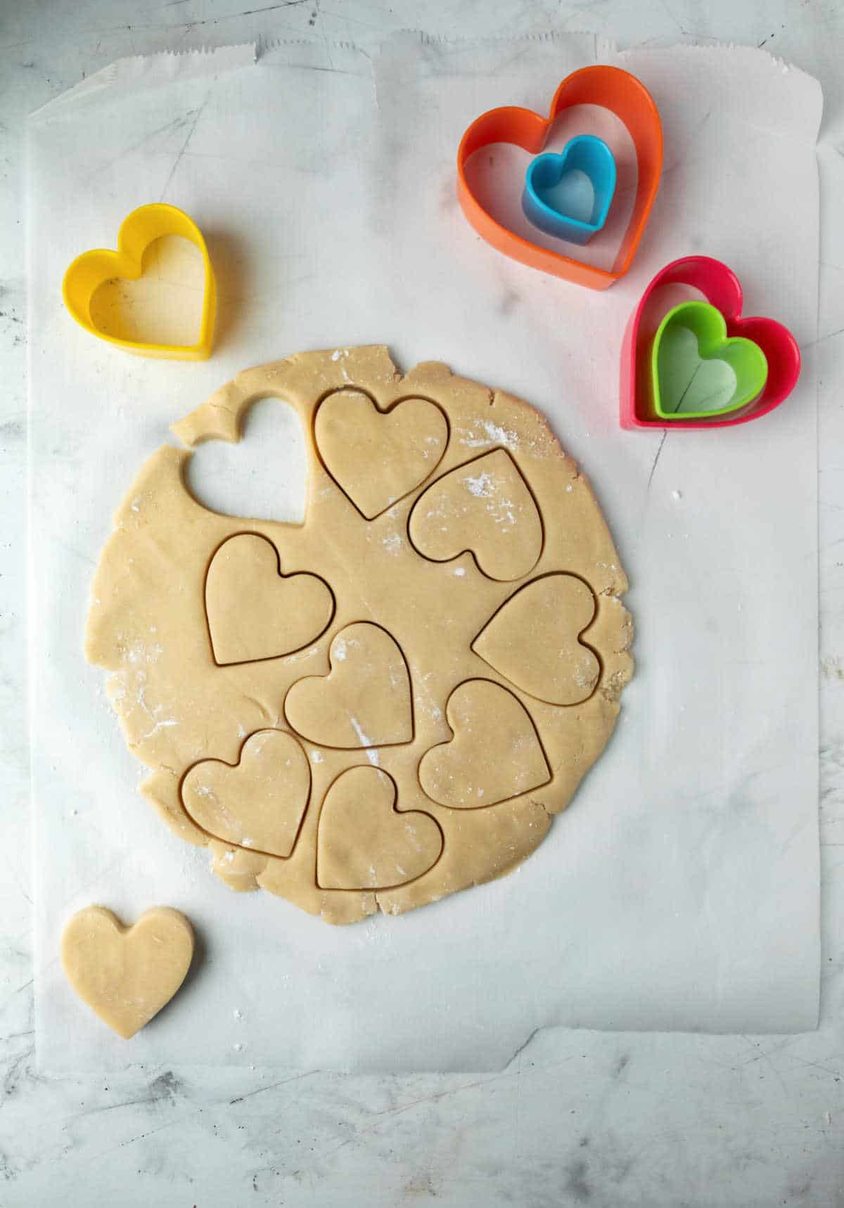 Dough with heart shaped cut outs in it. 