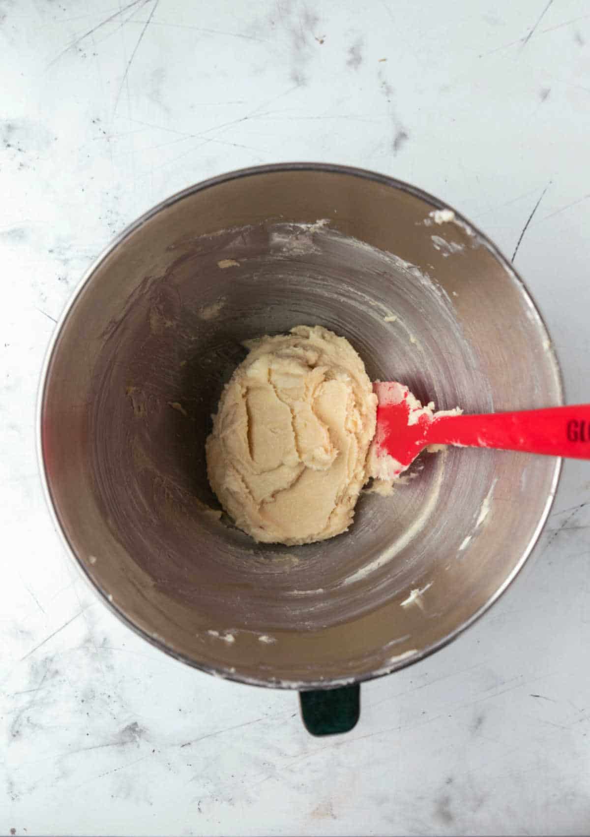Creamed butter and sugar in a silver mixing bowl.