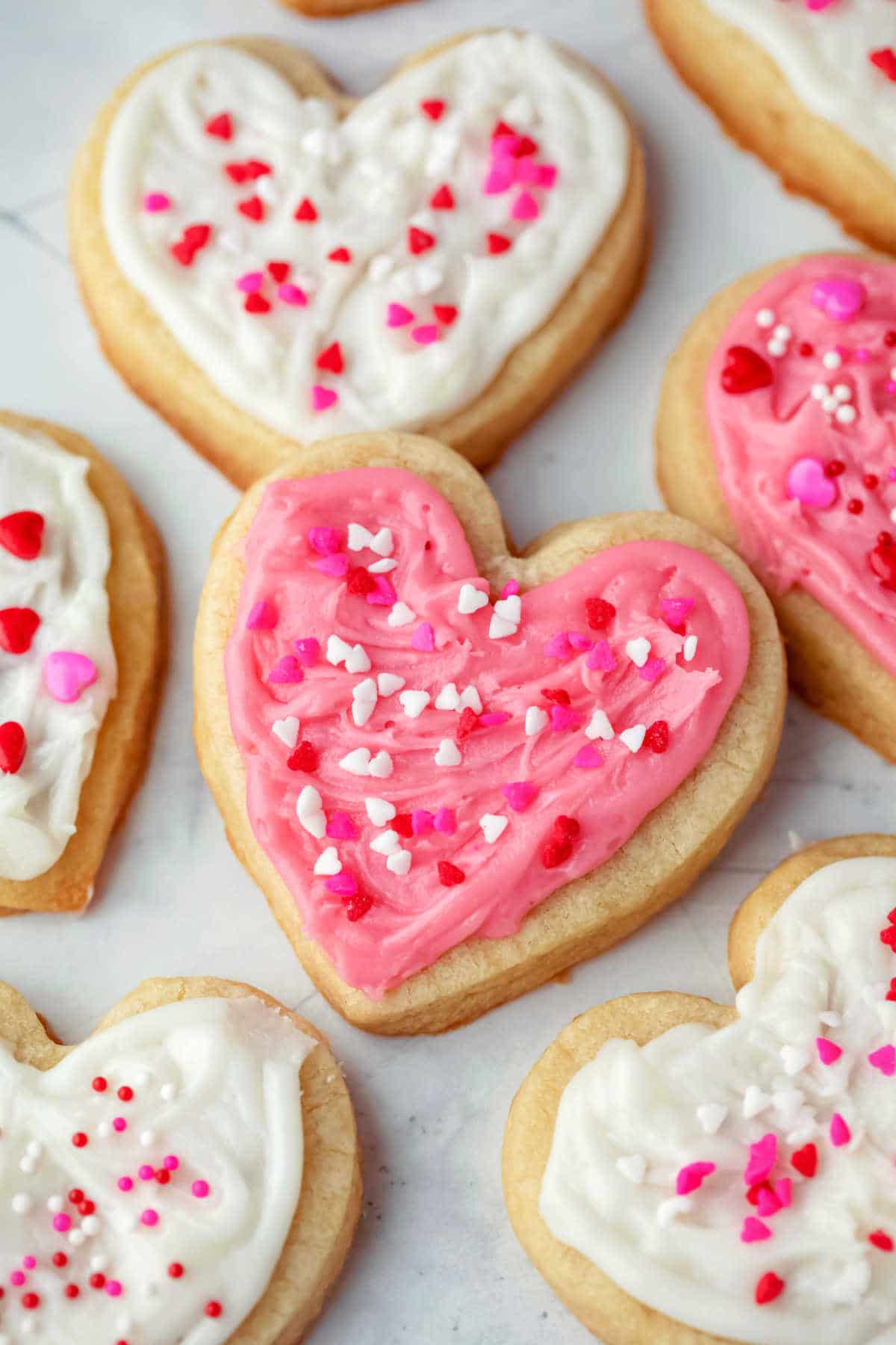 Heart shaped sugar cookie frosted with pink icing. 