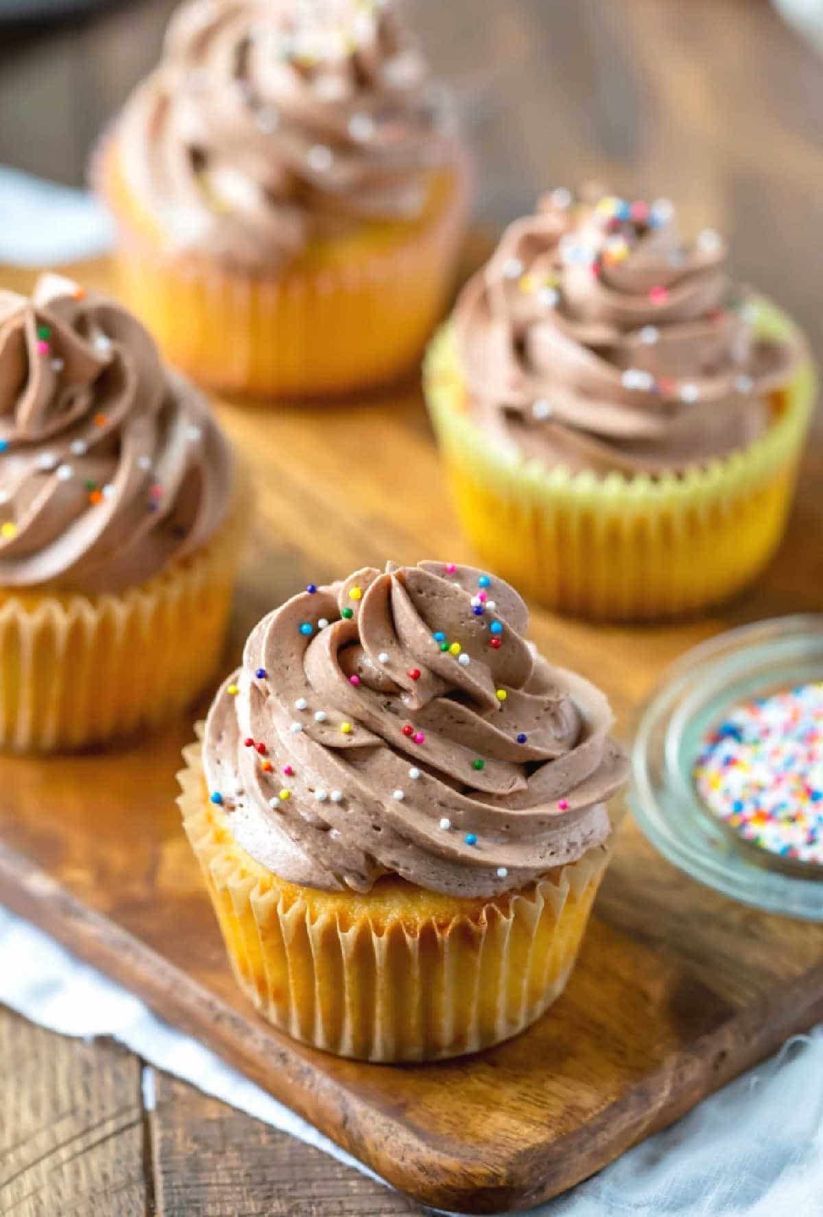 Chocolate whipped buttercream frosting on a yellow cupcake. 