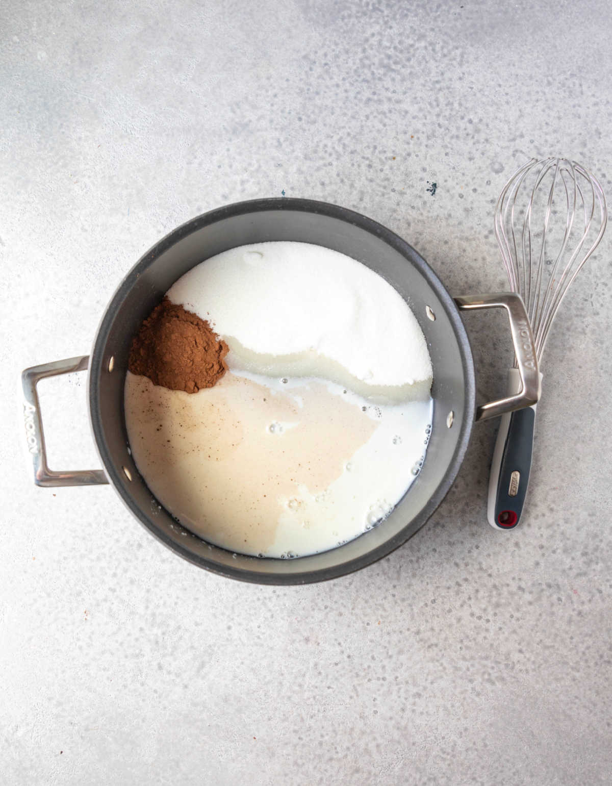 Cocoa powder milk and sugar in a saucepan.