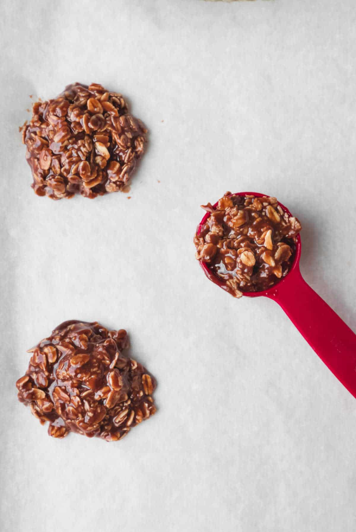 No bake cookie mixture in a measuring spoon. 