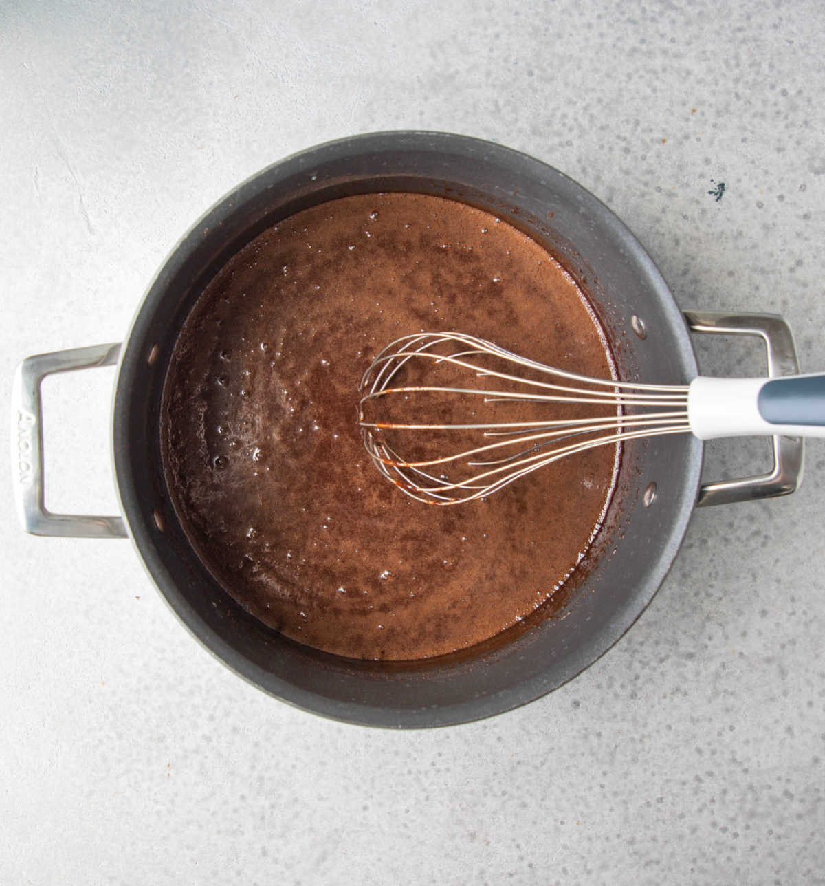 Boiled milk and cocoa powder mixture in a saucepan. 