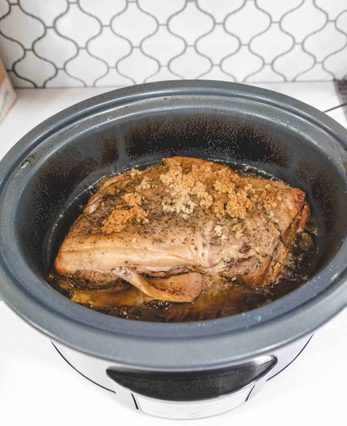 Cooked Cuban mojo pork in a slow cooker. 