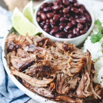 Plate with slow cooker Cuban mojo pork black beans and rice.