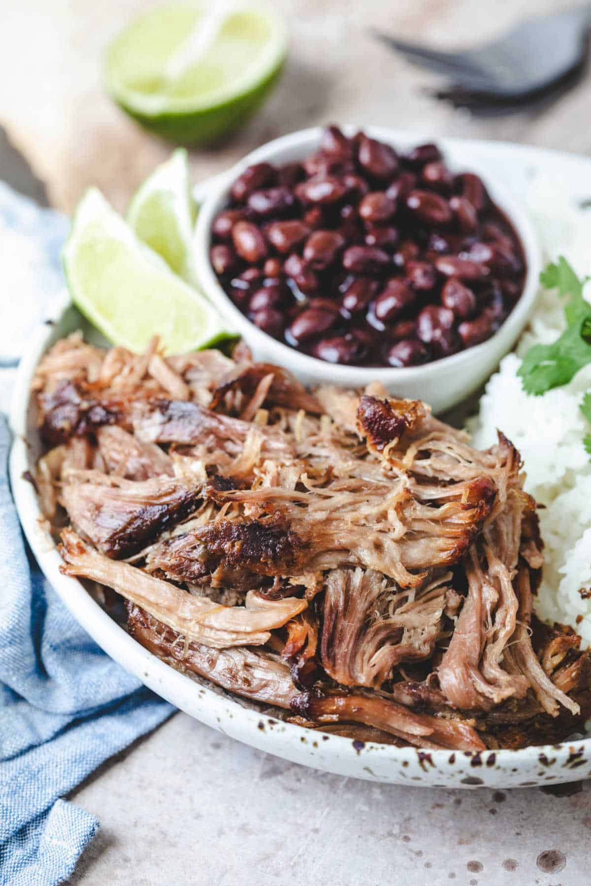 Plate with slow cooker Cuban mojo pork black beans and rice. 