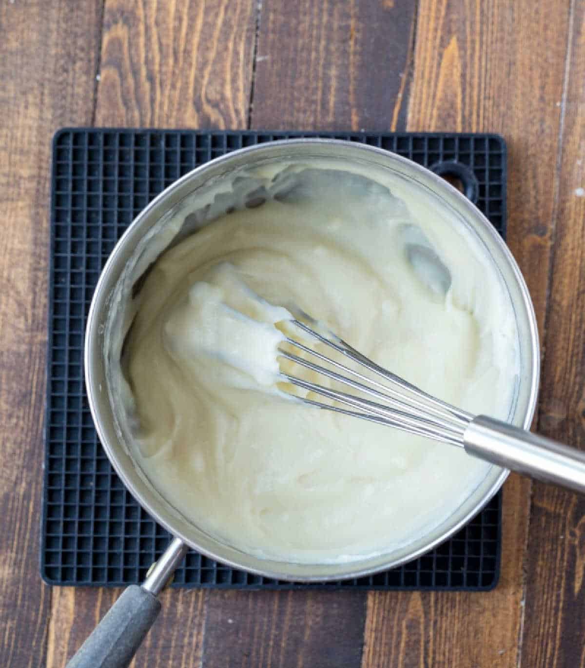 Cooked milk and flour mixture in a small saucepan. 