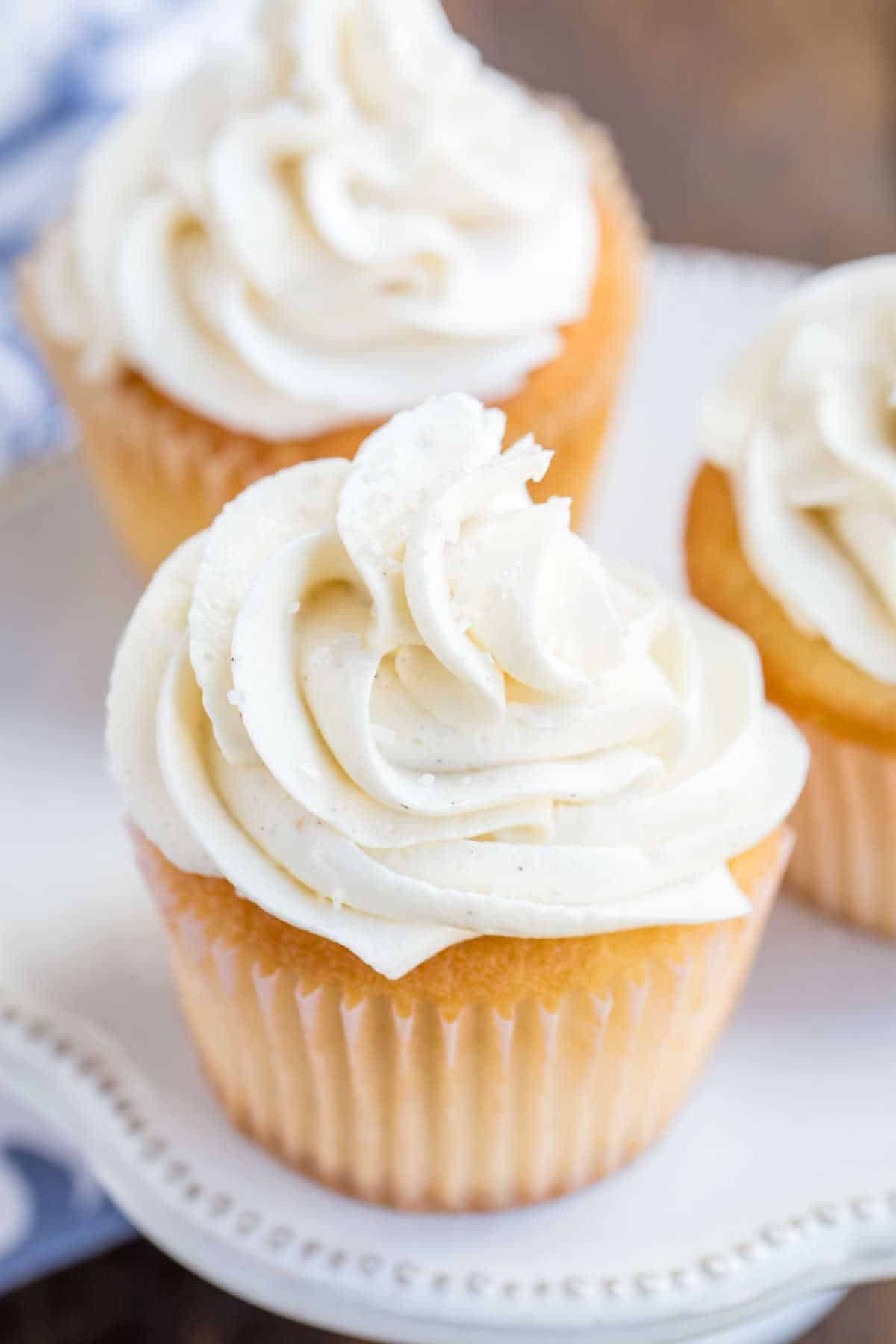 White cupcake with white ermine frosting on it. 