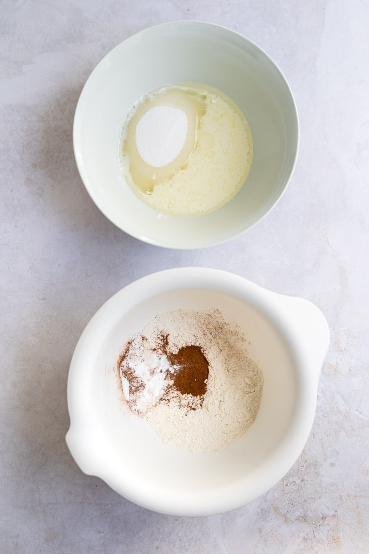 Wet and dry ingredients for carrot cake in bowls. 