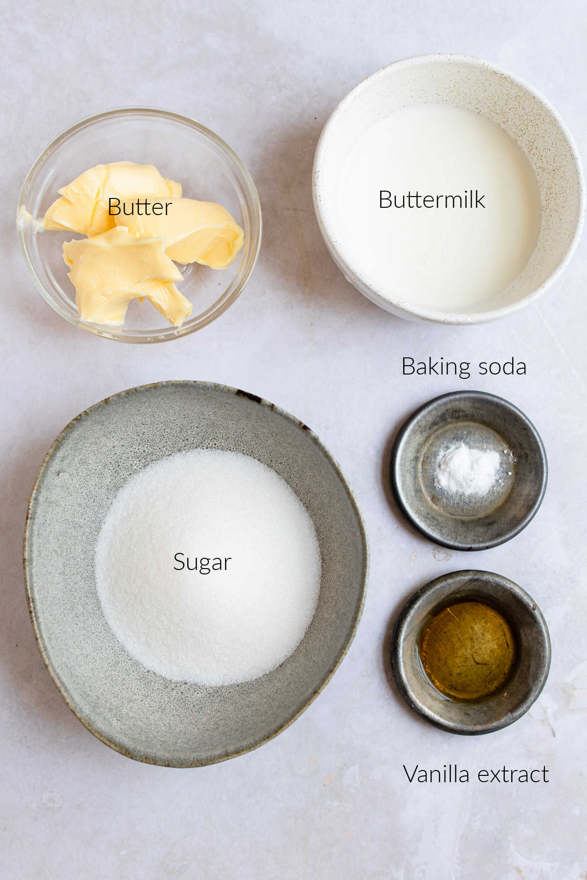 Ingredients for buttermilk glaze in dishes with labels. 