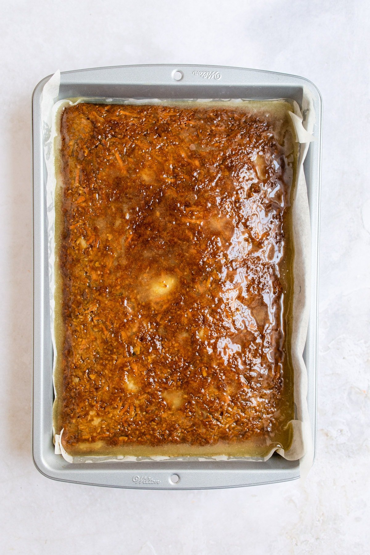 Buttermilk glaze on a carrot sheet cake.