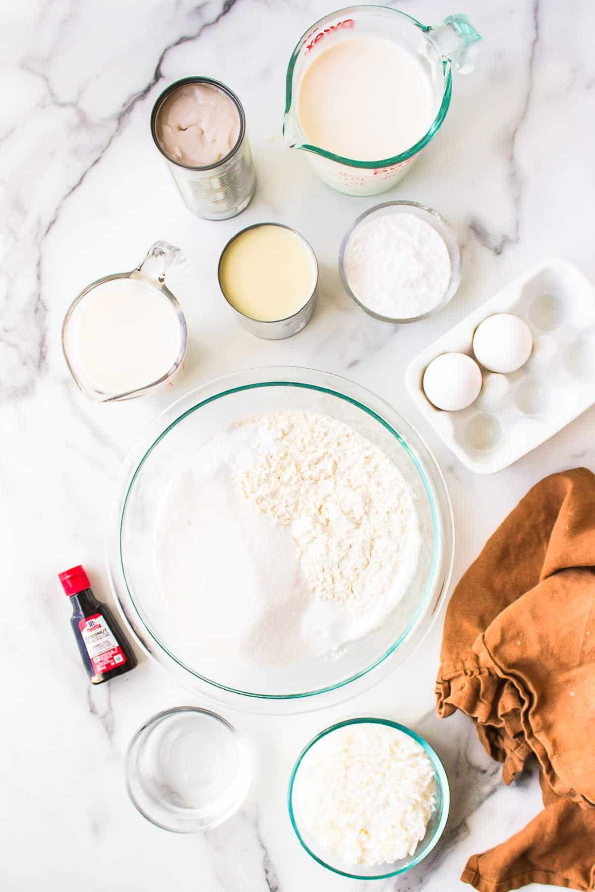 Ingredients for coconut poke cake in dishes. 