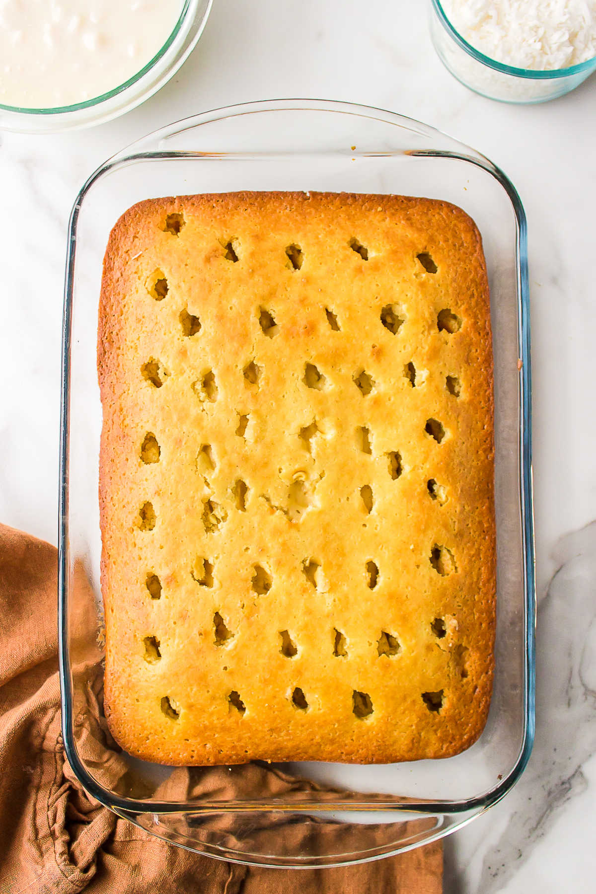 Baked cake with holes poked into it. 