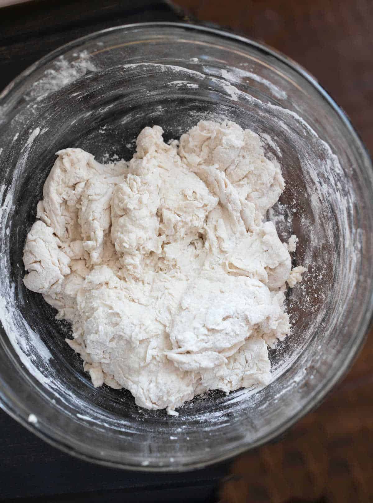 No knead bread dough in a glass mixing bowl. 