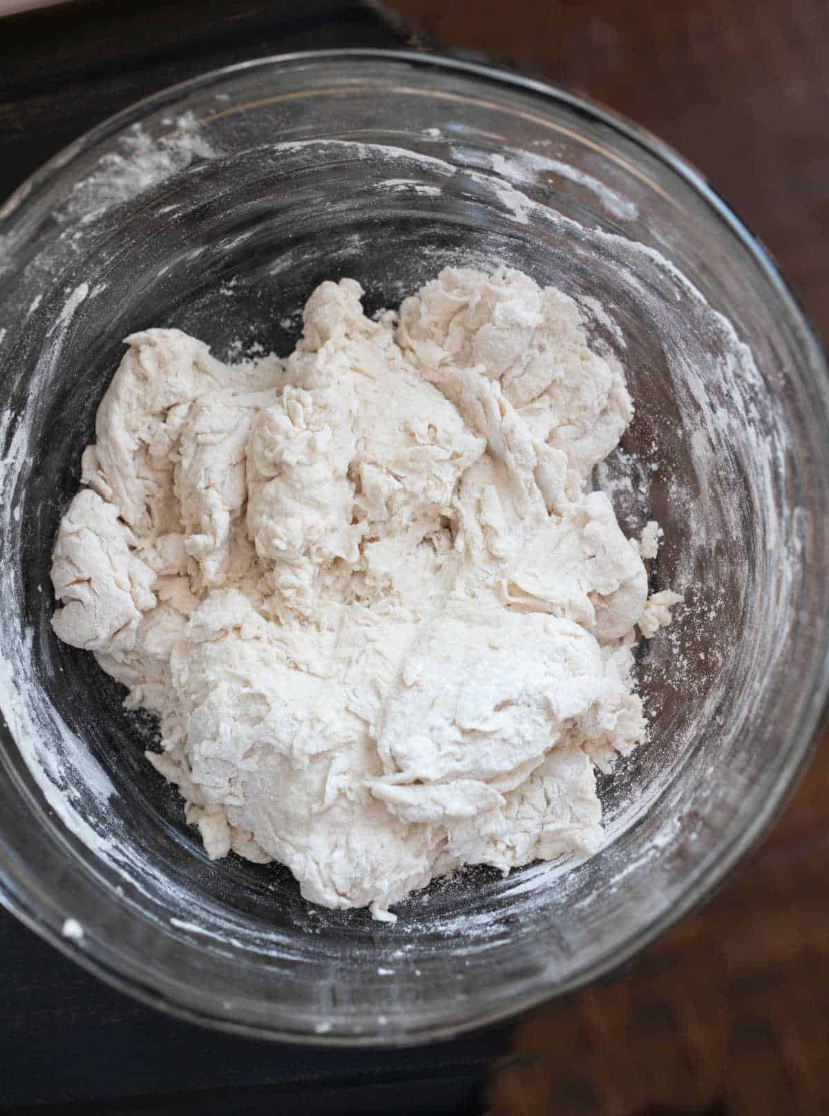 No knead bread dough in a glass mixing bowl.