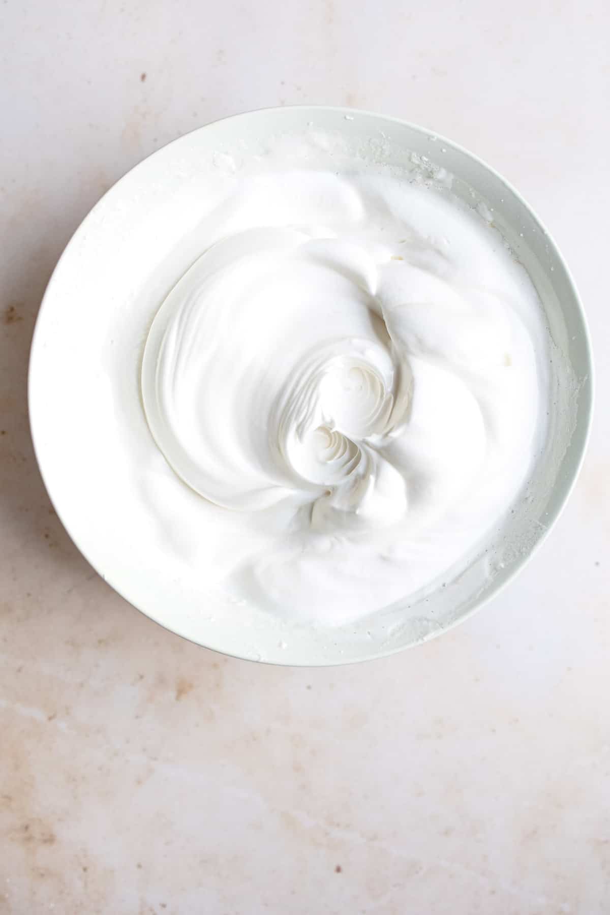 Whipped egg whites in a bowl.