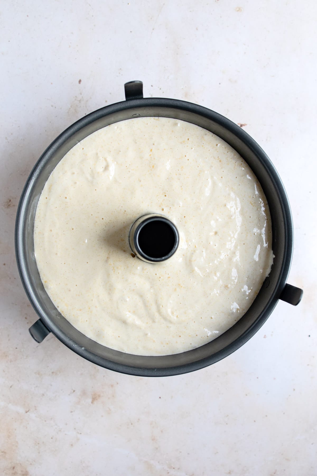 Sponge cake batter in a tube cake pan. 