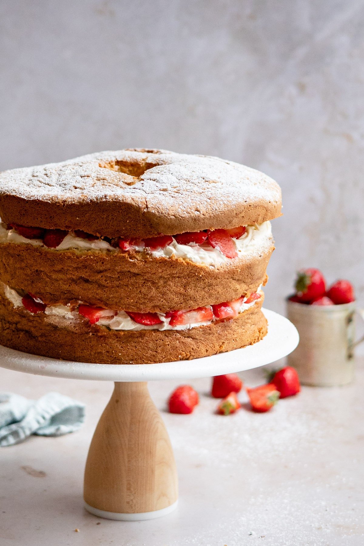 Strawberry shortcake cake on a cake stand. 