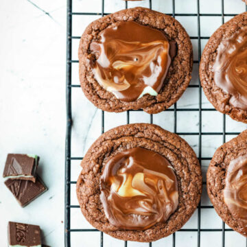 Andes mint cookies on a black wire cooling rack.