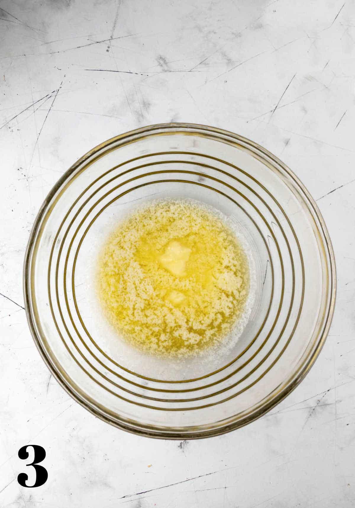 Melted butter in a glass mixing bowl. 