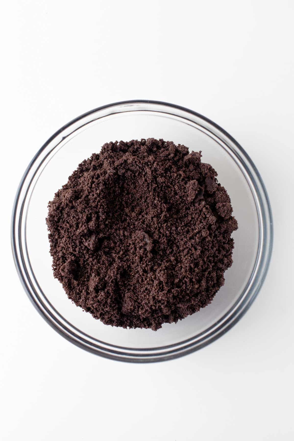 Oreo cookie crumbs in a glass bowl. 