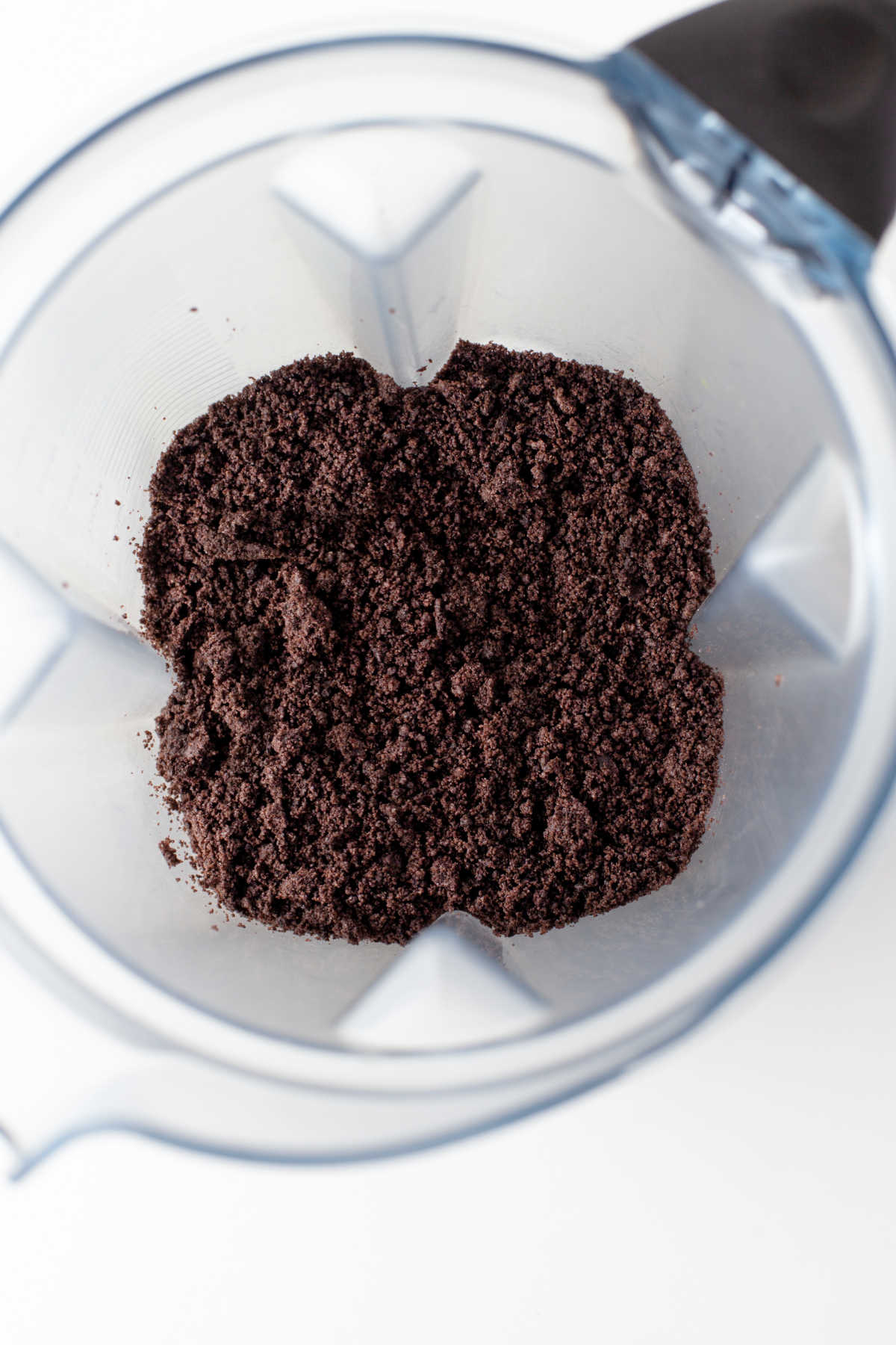 Oreo cookie crumbs in a food processor.