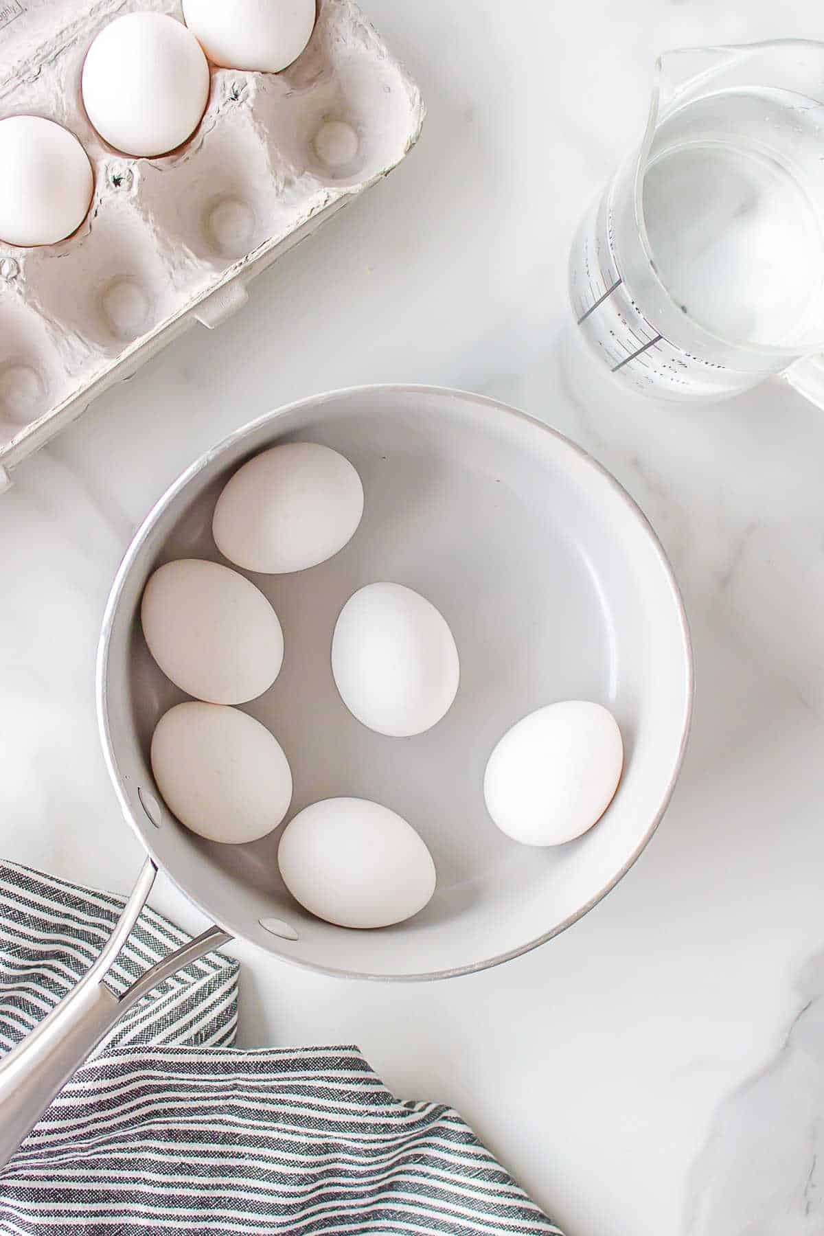 Eggs in a pot of cold water.