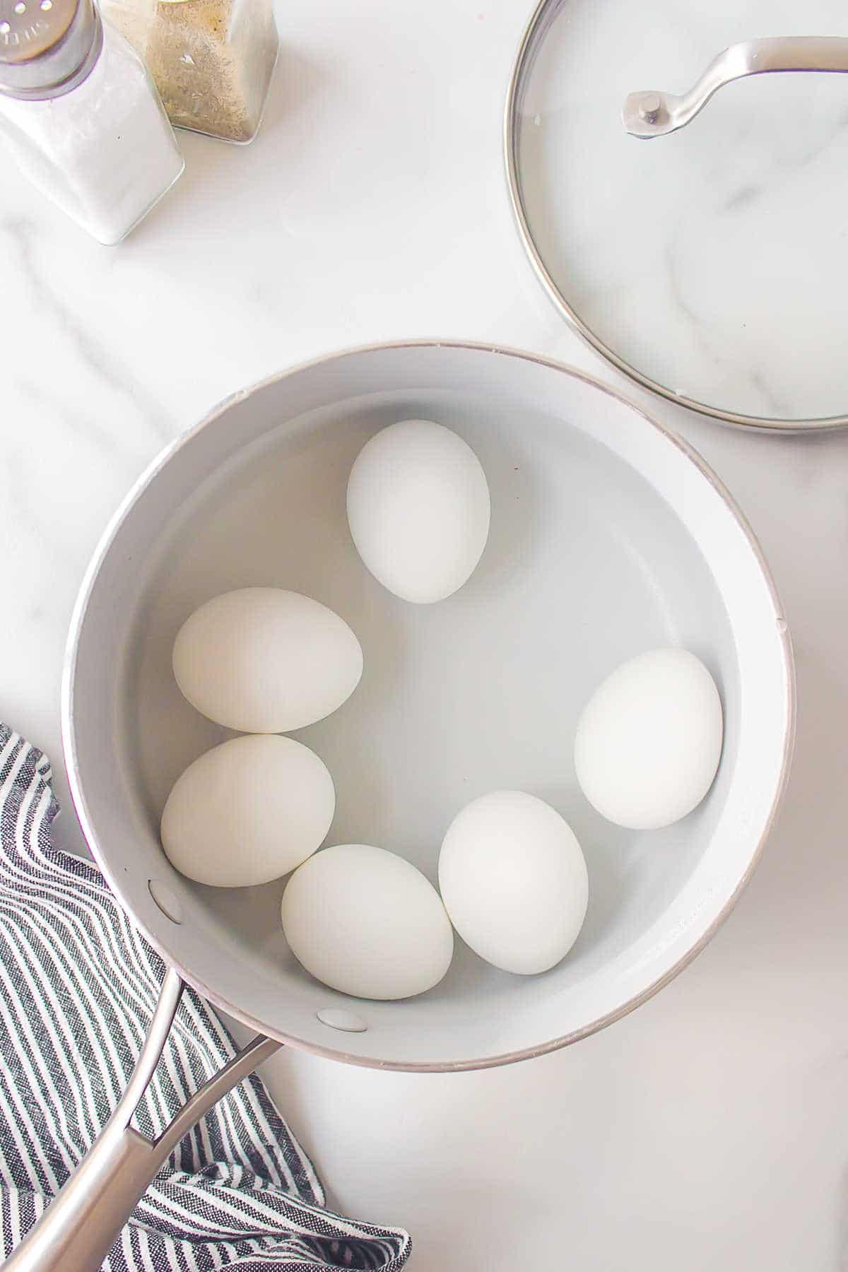 Boiled eggs in a pot of water. 