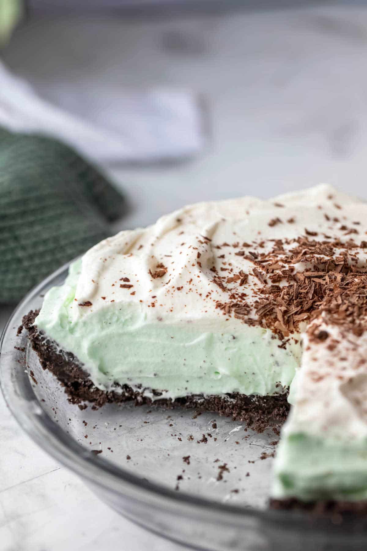 A grasshopper pie with a slice cut out of it.