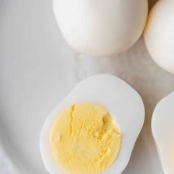 A hard boiled egg sliced in half and topped with salt.