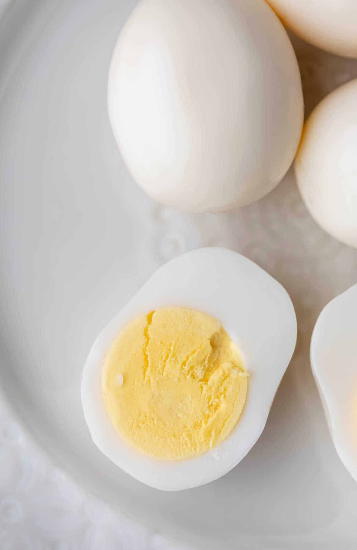 A hard boiled egg sliced in half and topped with salt. 