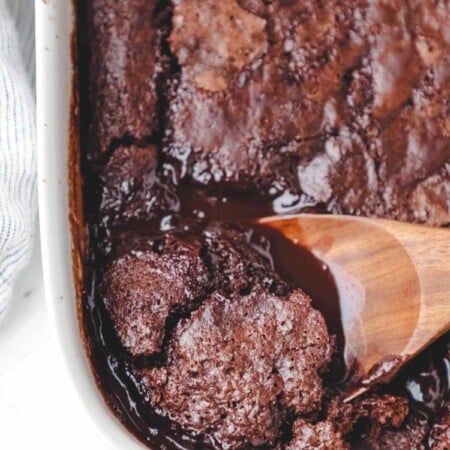A wooden spoon in a hot fudge chocolate pudding cake.