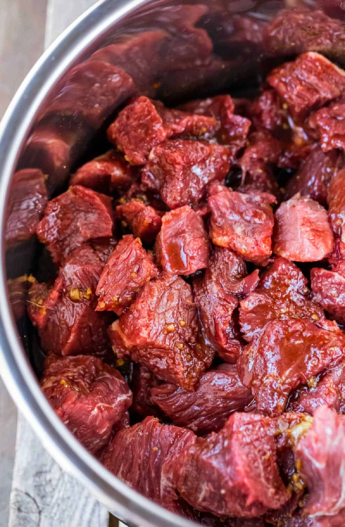 Cubes of beef in an Instant Pot inner pot.