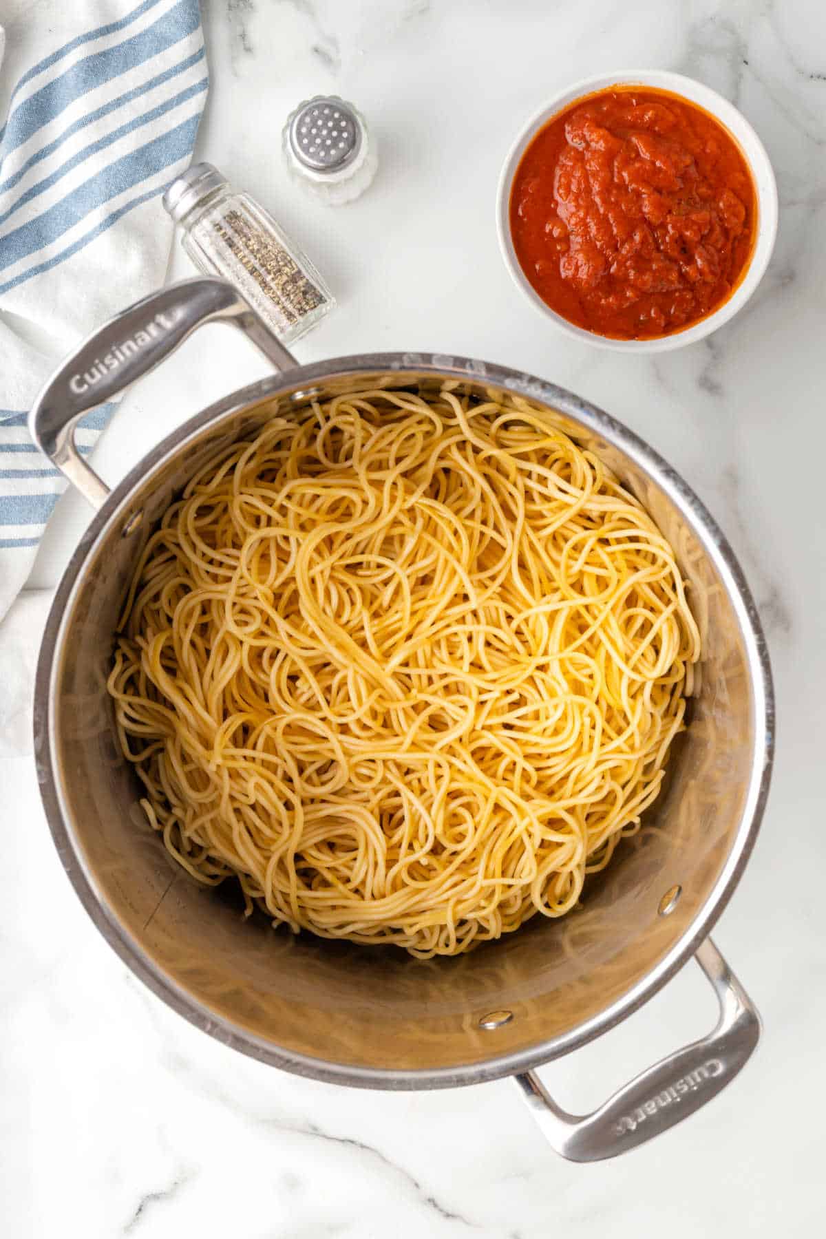 Cooked spaghetti noodles in a pot.