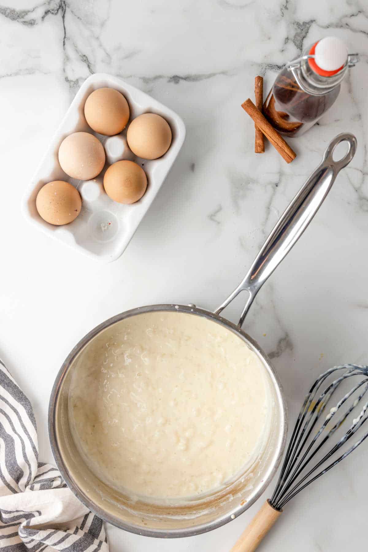 Cooked rice pudding in a silver saucepan.