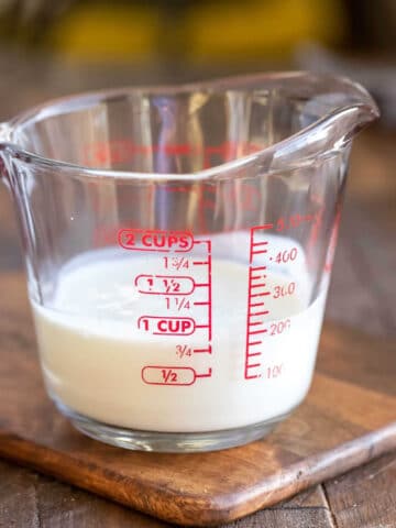Buttermilk substitute in a glass measuring cup.
