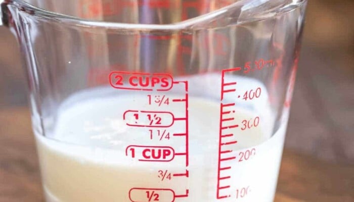 Buttermilk substitute in a glass measuring cup.