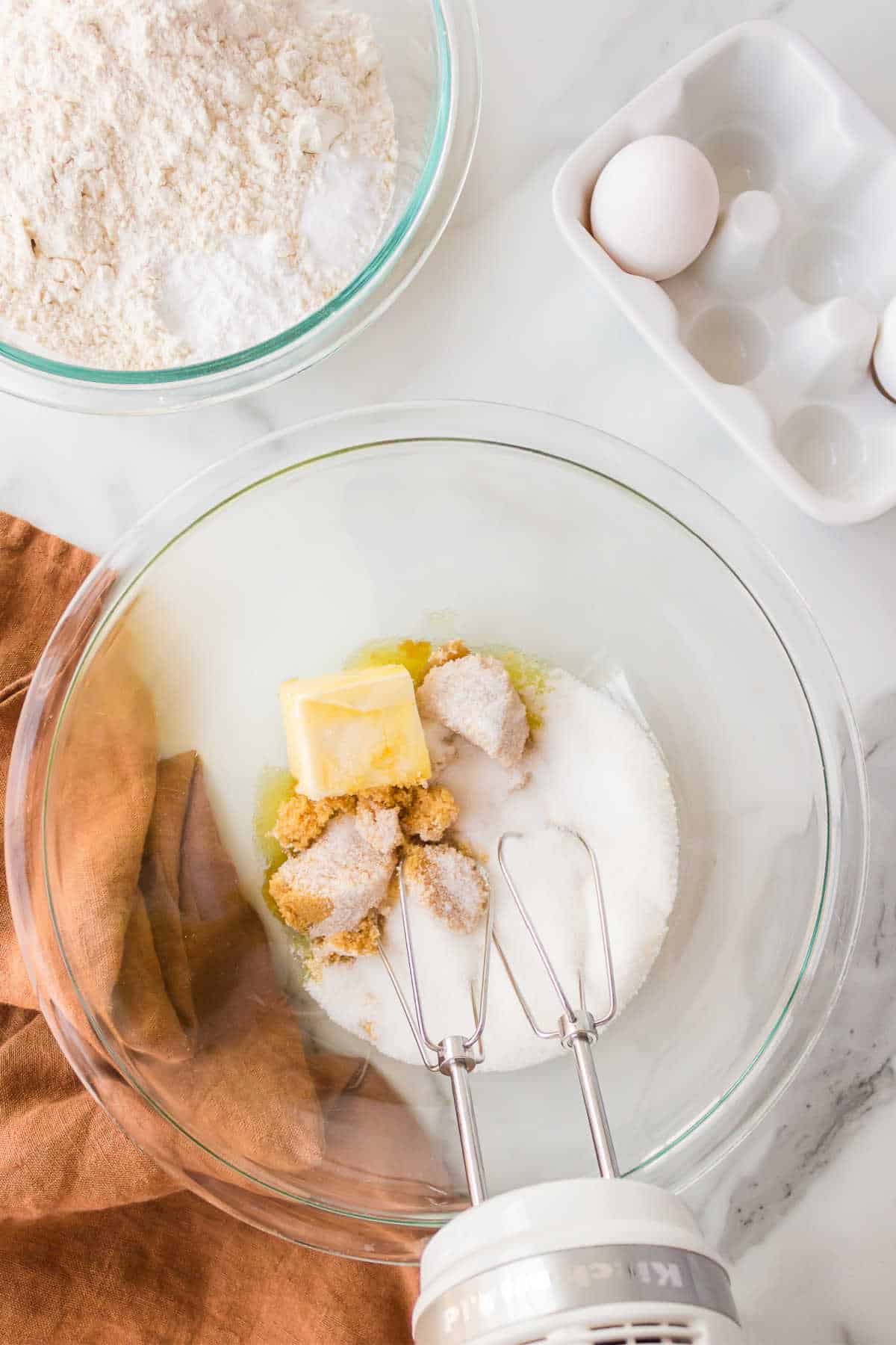 Butter sugars and oil in a mixing bowl. 