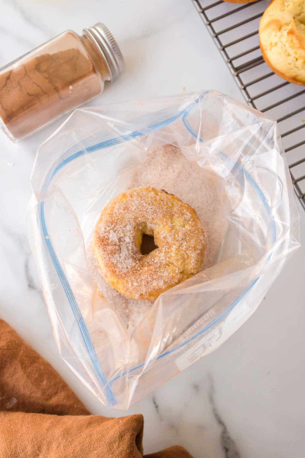 A churro donut in a plastic bag. 