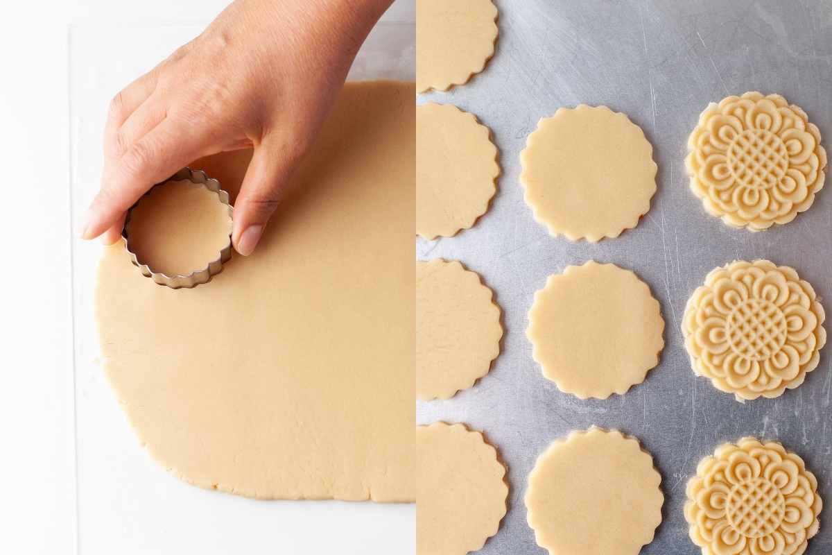 A fluted cookie cutter cutting cookies from rolled out dough.