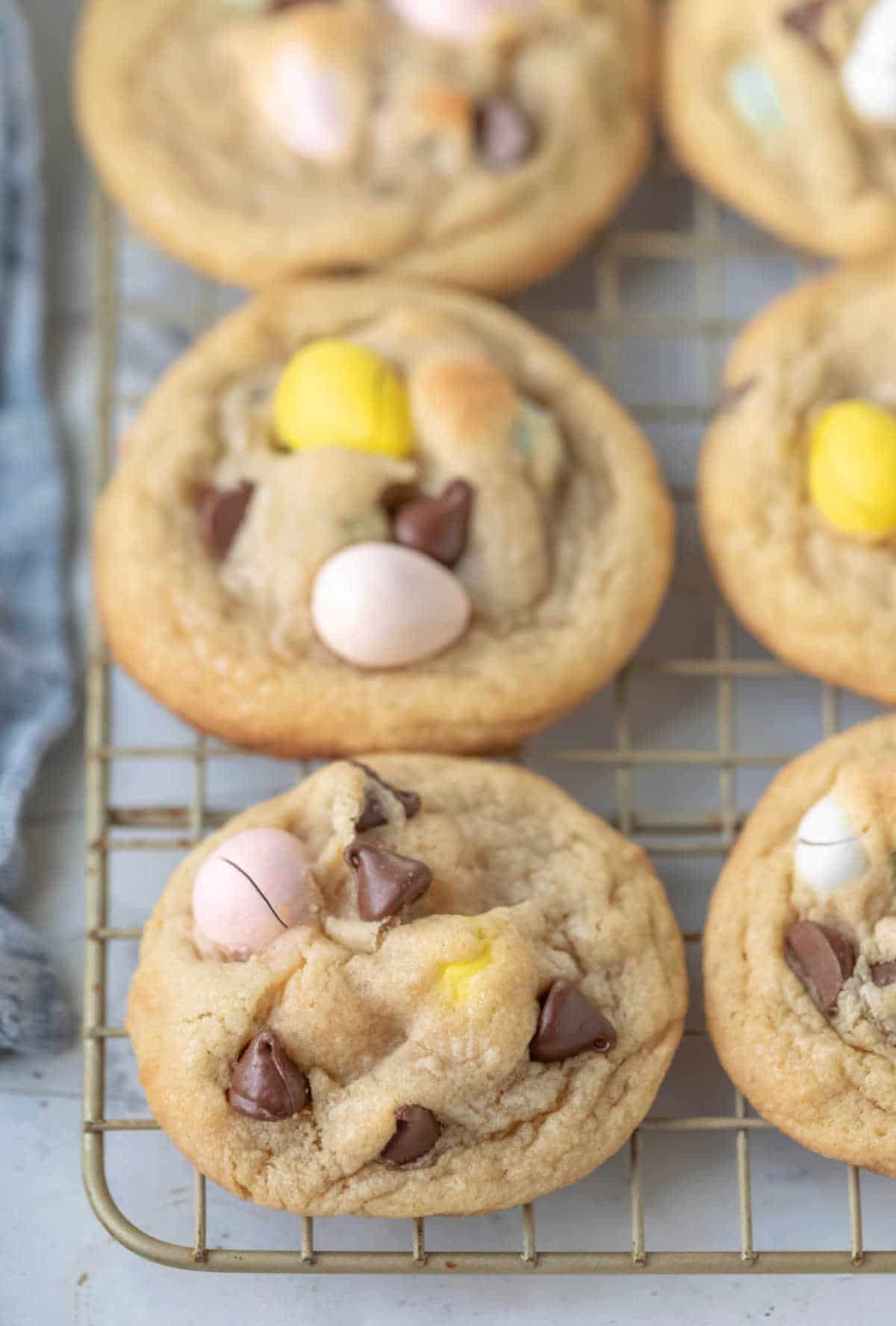 Cadbury egg cookies on a wire cooling rack. 