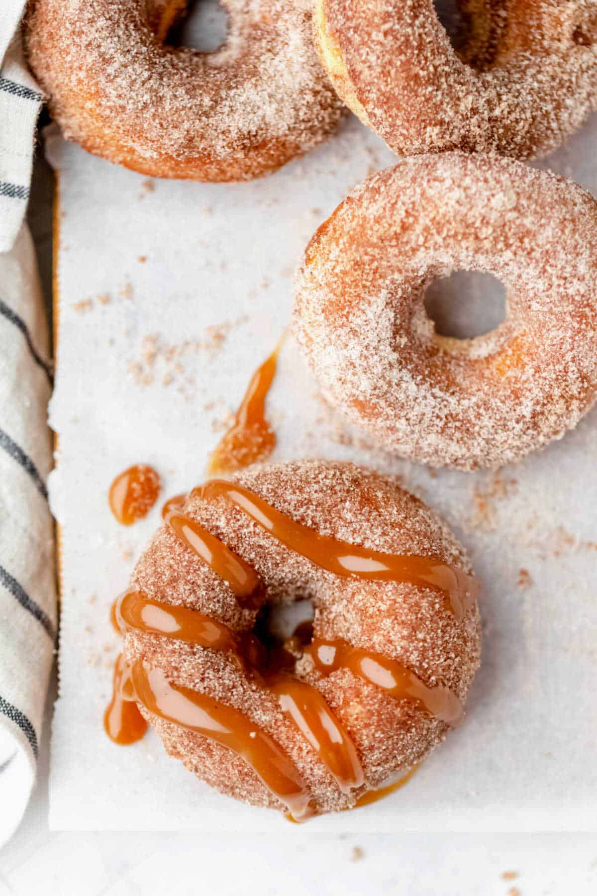 Overhead photo of churro donuts on parchment paper. 