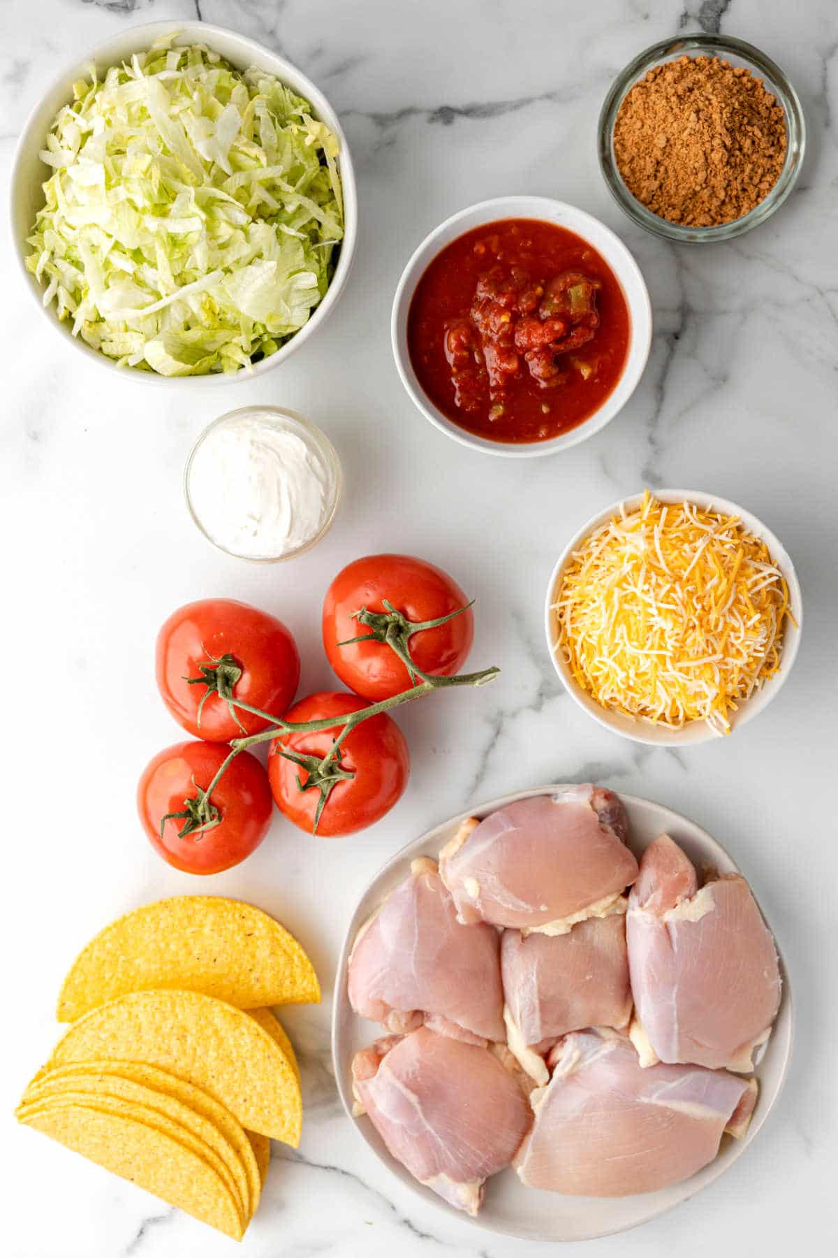 Ingredients for crock pot chicken tacos in dishes. 
