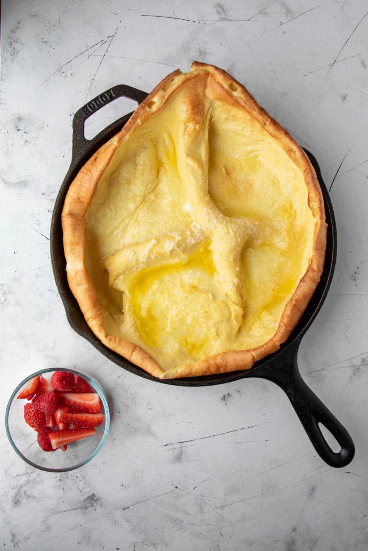 Cooked German pancake in a cast iron skillet.