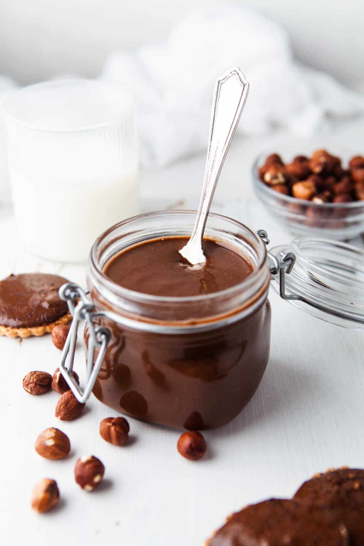 A silver spoon in a jar of homemade nutella. 