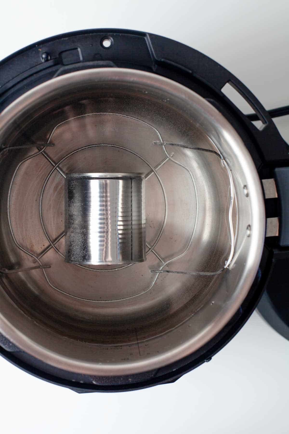 A cooked can of sweetened condensed milk on a wire trivet. 