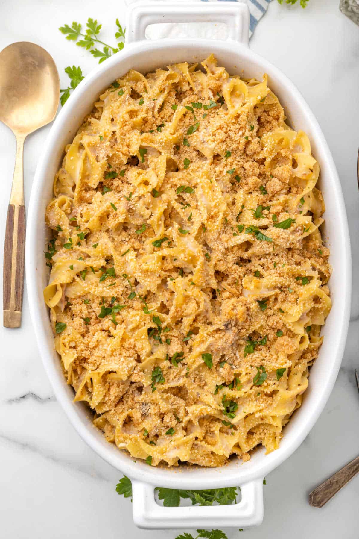 Tuna noodle casserole in a white baking dish.