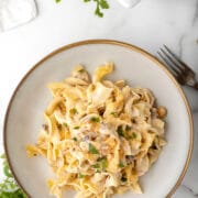 Tuna noodle casserole in a cream dish.