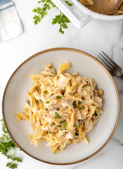 Tuna noodle casserole in a cream dish.